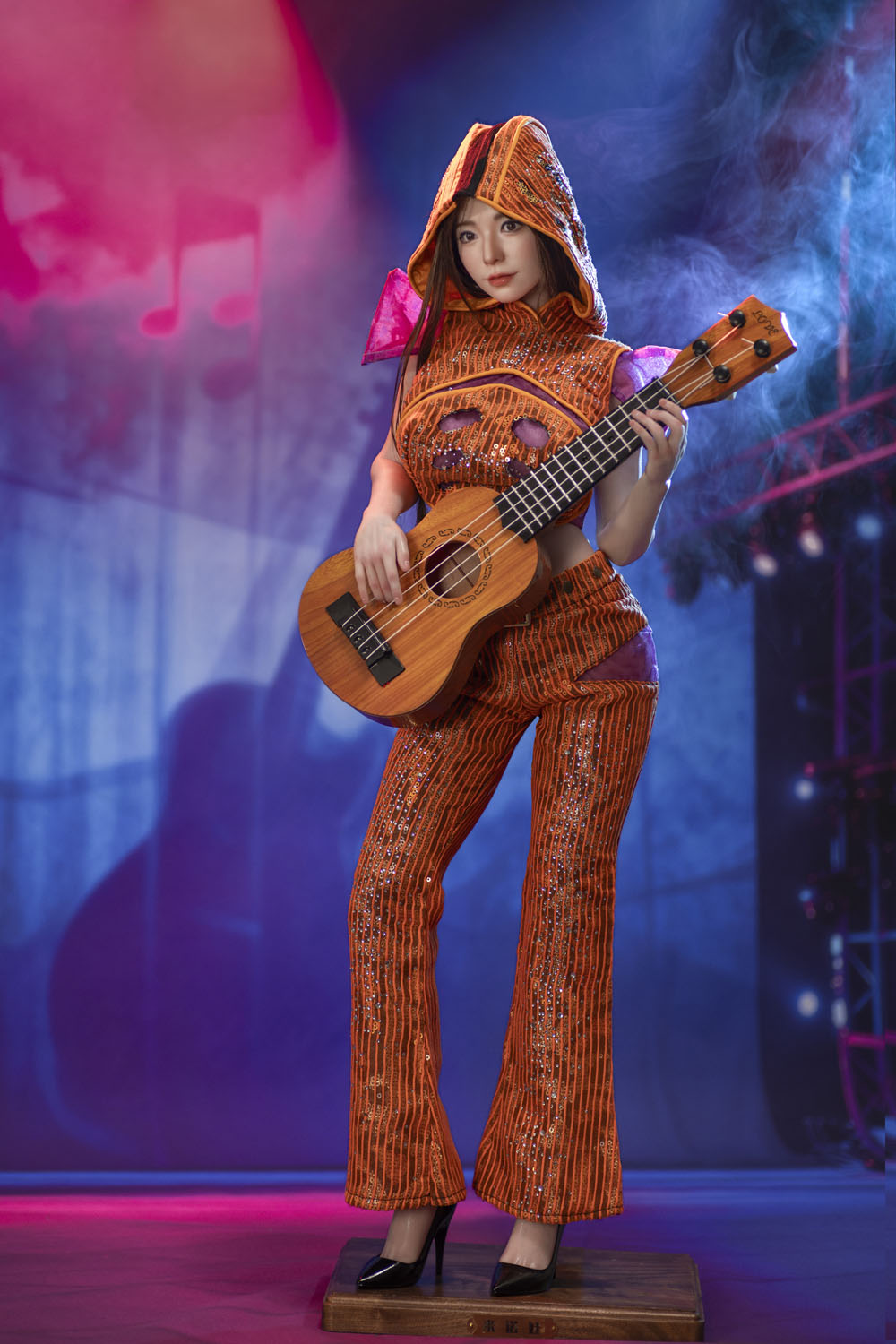 Standing art figure holding a ukulele on stage