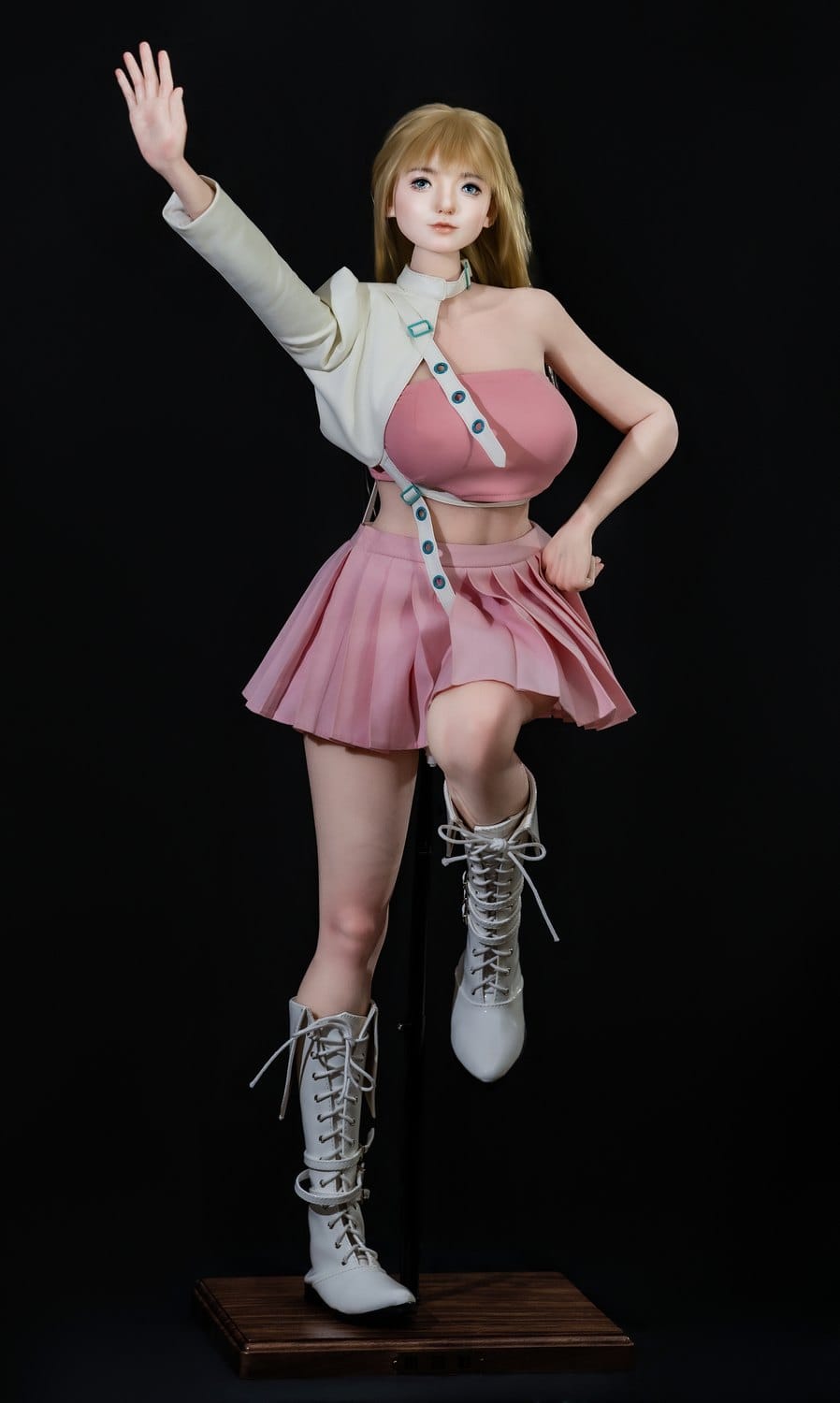 Action pose in pink skirt and white boots