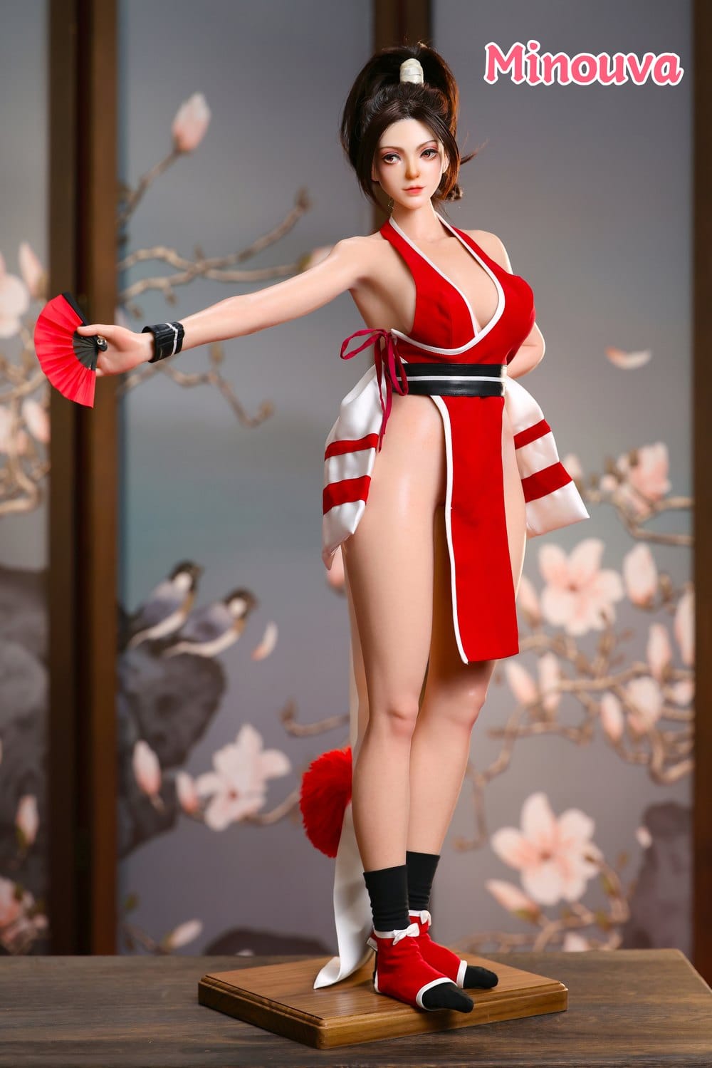 Standing figure with fan on wooden base